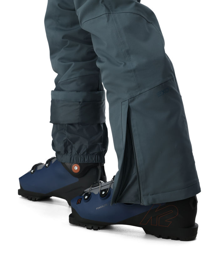 Dark gray pants with blue ankle boots on a white background
