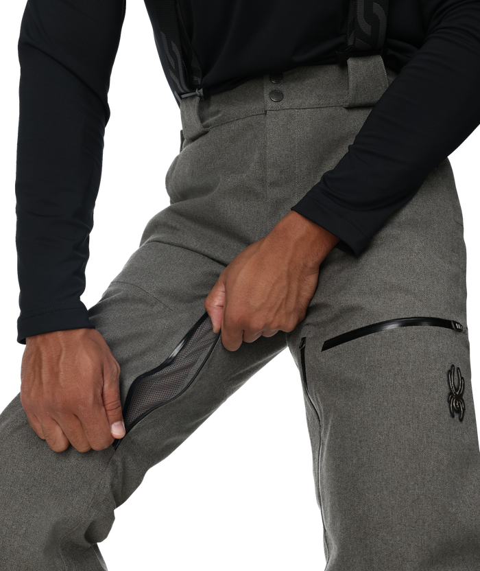 Gray pants with zippers and a black long-sleeve shirt on a white background
