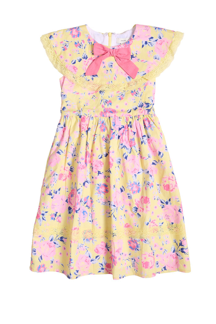 The front of a childrens yellow floral dress with a pink on the front against a white background