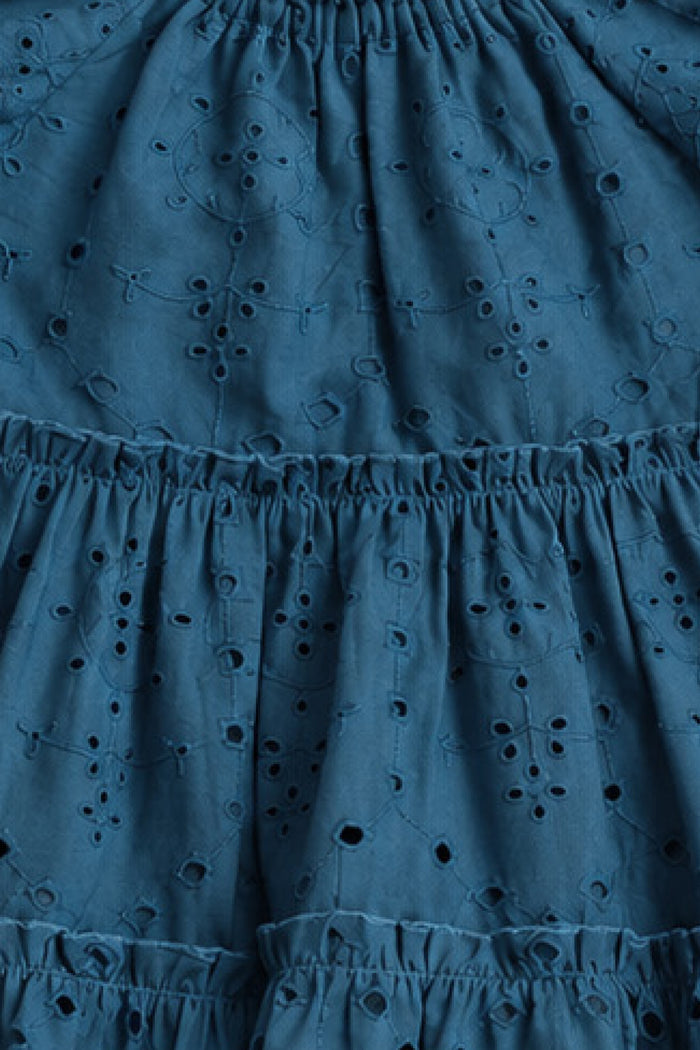 Close-up of blue eyelet embroidery and ruffled, tiered seams on the Mini Etta Dress in Cobalt by Ivy City Co—perfect for a girl's cotton dress or mom and me matching outfits.