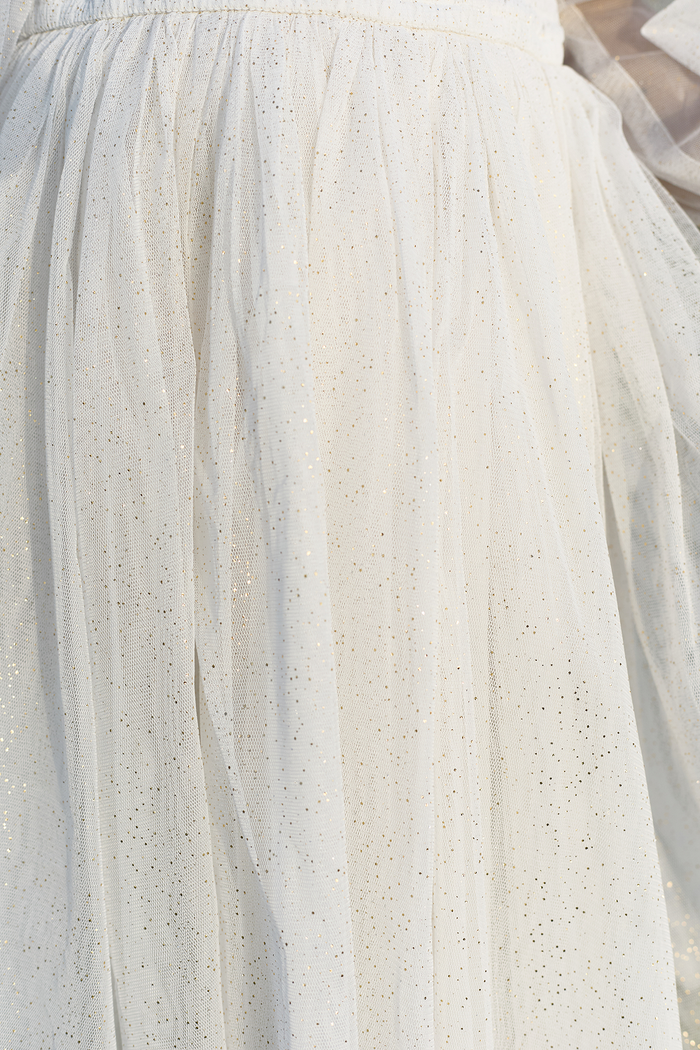Close-up of sheer white tulle with subtle shimmer and fine glitter, gathered at the waist—perfect for the Ivy City Co Mini Stella Dress in White or an elegant flower girl dress.