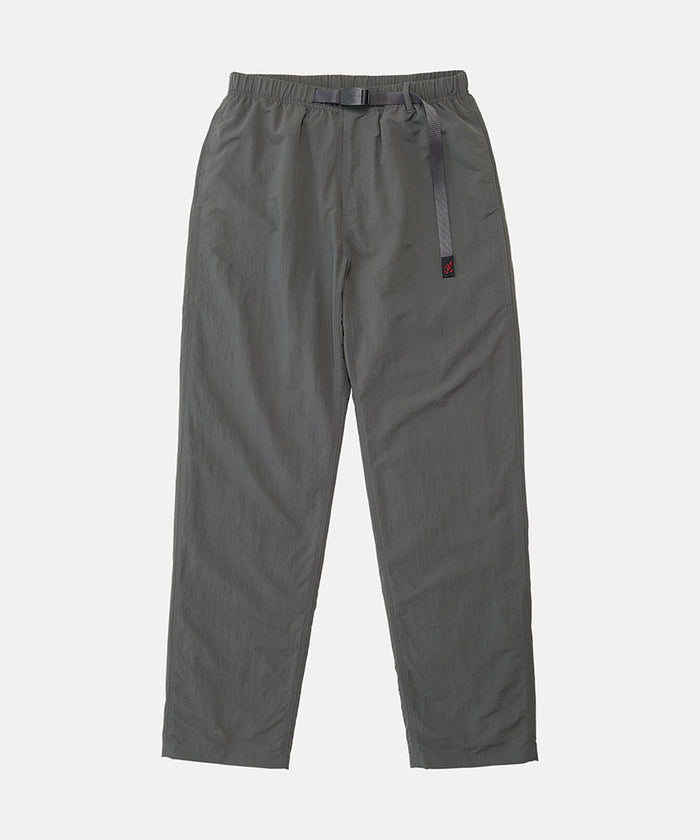 Carbon colored Nylon Gramicci Pants with a belt against a light-tone background.