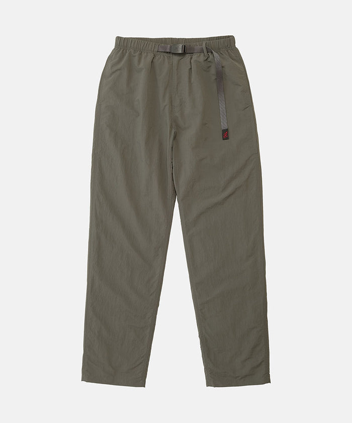 Burnt olive colored Nylon Gramicci Pants with a belt against a light-tone background.