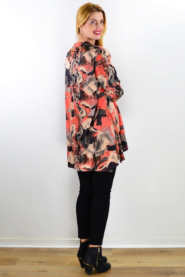 Orange beige satin tunic shirt by Caroline Morgan featuring a relaxed fit and elegant drape, displayed on a hanger.