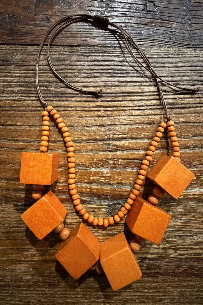 Orange square blocks necklace by I Love Tunics featuring bold geometric design and vibrant orange color.