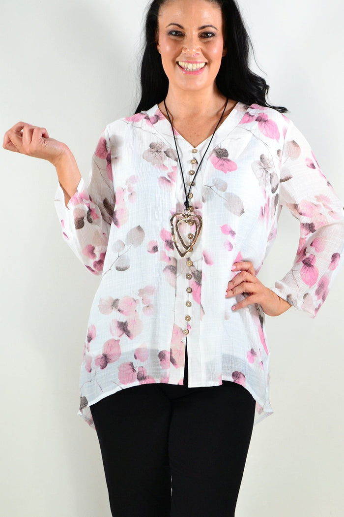 Pink floral botanical tunic top by Caroline Morgan, featuring a vibrant floral pattern and relaxed fit in the image.