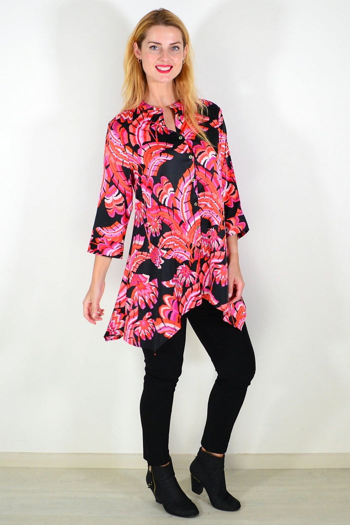 Pink orange satin tunic shirt by Caroline Morgan, featuring a flowy fit and stylish design, shown on a hanger.