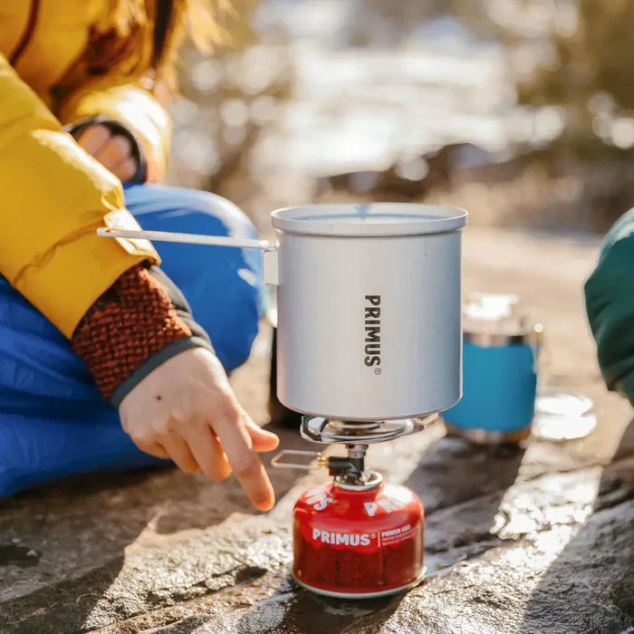 Lifestyle image of a person using a Primus Essential Trail Kit outdoors