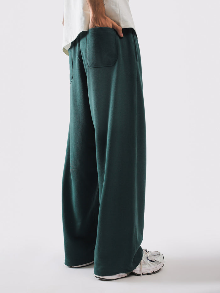 Deep green sweatpants styled with a cream tee - GROOVY Pakistan