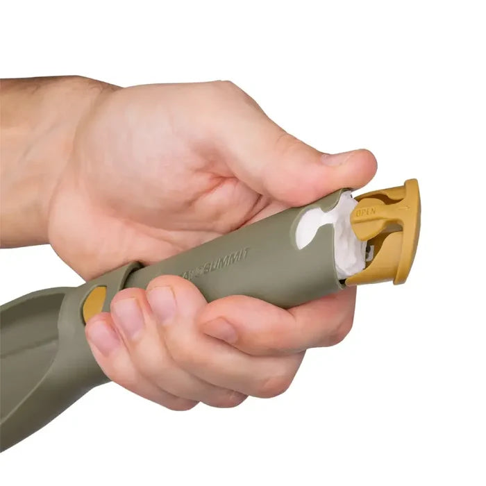 Hand holding a Sea To Summit Nylon Pocket Trowel in reverse showing the base storage area on a white background