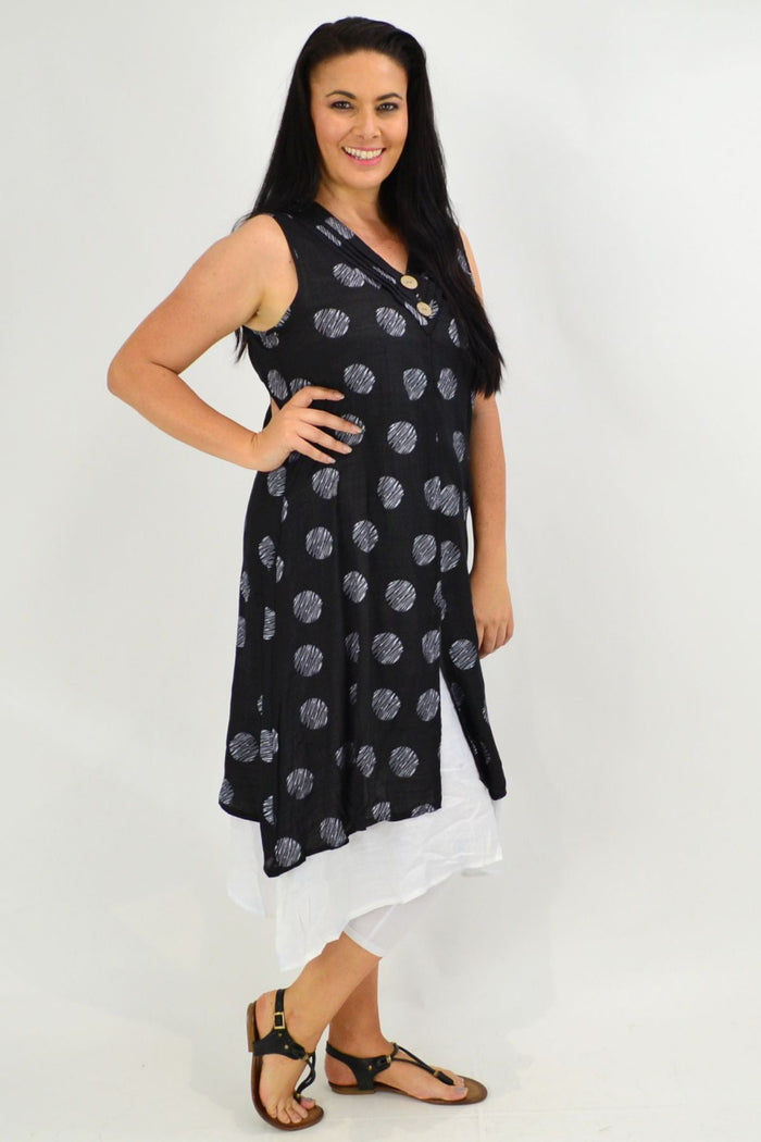 Black sleeveless tunic dress with white polka dot overlay, stylish La Mode women's tunic, front view with flowing fabric.