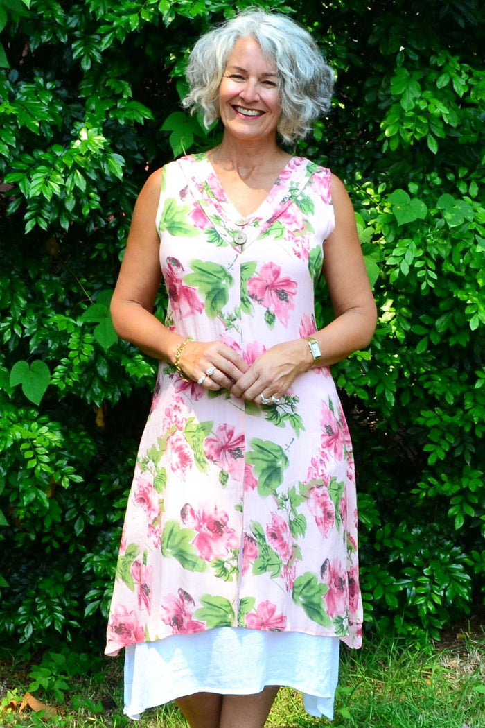 Pink summer garden tunic dress by La Mode, featuring lightweight fabric and floral pattern, displayed on a hanger.