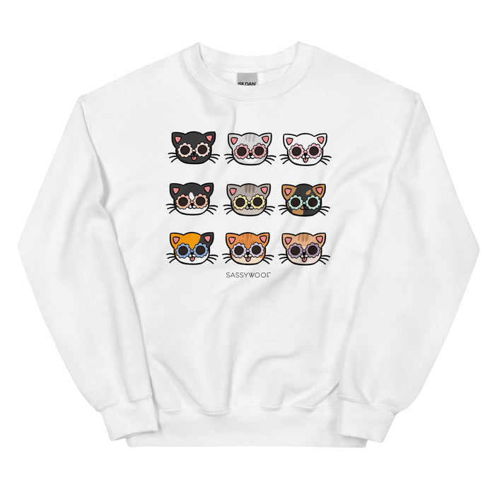 The Sassy Woof Sweatshirt - Cats is a comfy white unisex crewneck featuring a grid of nine cartoon cat faces with sunglasses and “SASSYWOOF” printed below—ideal cat apparel for any feline fan.
