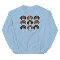 The Sweatshirt - Cavaliers by Sassy Woof is a light blue unisex top featuring nine colorful cartoon dog faces in glasses and "SASSY WOOF" below—perfect for dog lovers who enjoy fun, playful style.