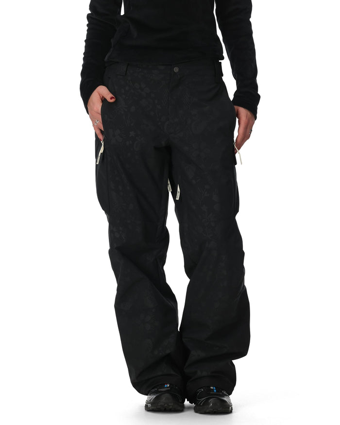 Person wearing black snow pants on a white background