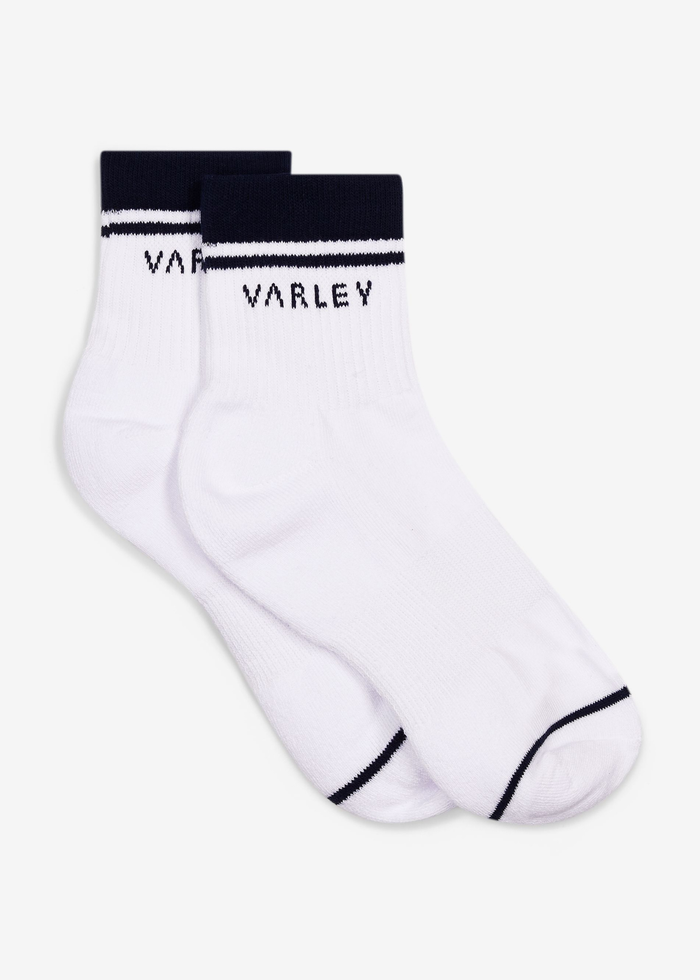 White socks with navy stripes and the Varley logo laying on a white background