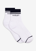 White socks with navy stripes and the Varley logo laying on a white background