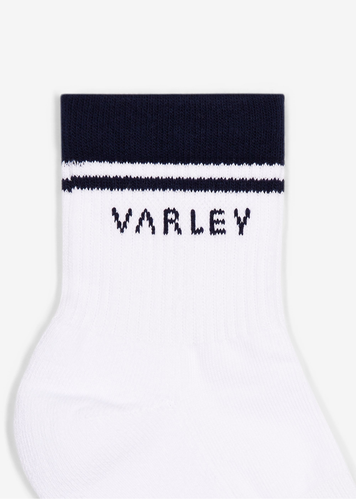 White socks with navy stripes and the Varley logo laying on a white background