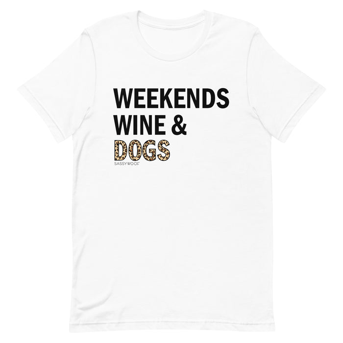 The Sassy Woof Weekends, Wine, & Dogs Tee is a unisex shirt made from 100% ring-spun cotton, featuring bold black text and "DOGS" in leopard print with a small Sassy Woof logo—perfect for dog lovers who enjoy wine on weekends.
