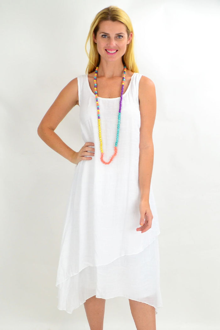 White asymmetrical hem tunic dress by Missy Q, loose summer style with flowing fabric and stylish design.