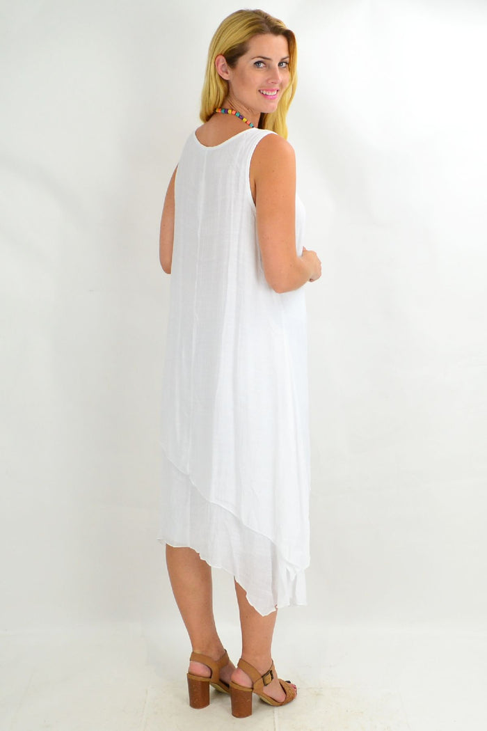White asymmetrical hem tunic dress by Missy Q featuring a loose fit and summer-ready style.